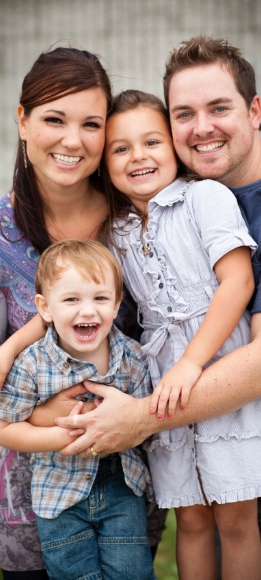 Parents and child smiling after family dentistry visit