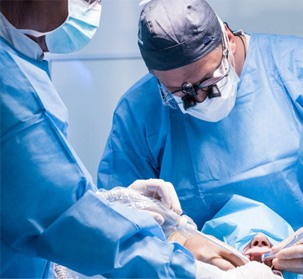 Dentists performing a dental implant surgery