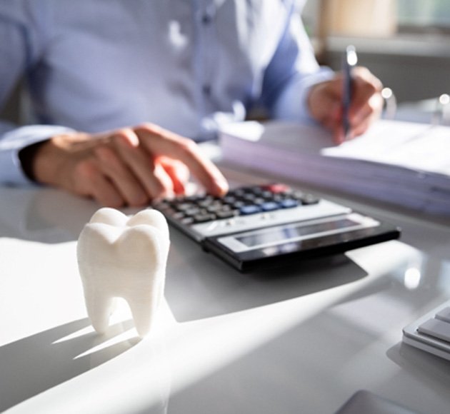 a man calculating the cost of Invisalign