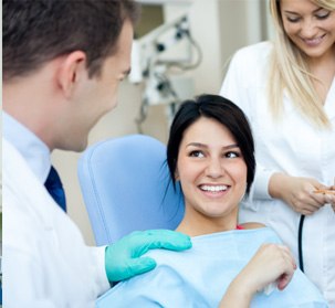 a woman at her Invisalign check-in appointment with her dentist