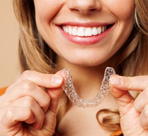 a woman putting Invisalign trays in