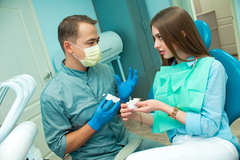 Patient talking to dentist about dental implants